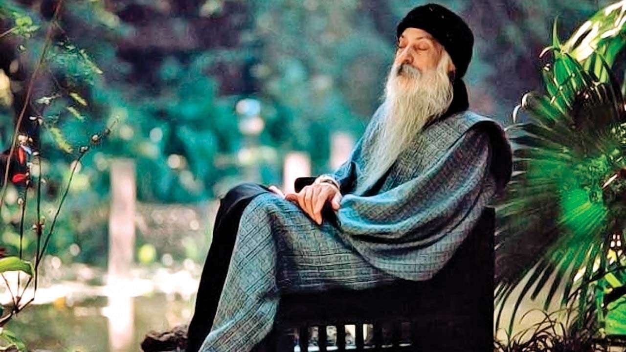 relaxed Osho with closed eyes in beautiful palm garden