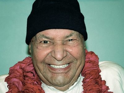 laughing Papaji with black hat and red Mala around his neck